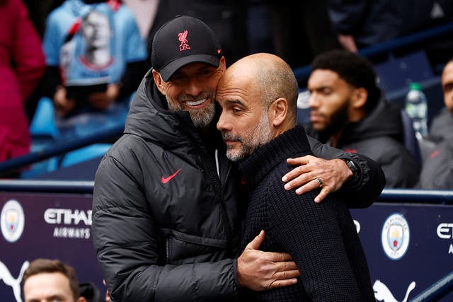 <p>Manchester City manager Pep Guardiola gets a warm welcome from his Liverpool counterpart Jurgen Klopp, who wants to make life ‘really uncomfortable’ for the champions on Saturday afternoon </p>