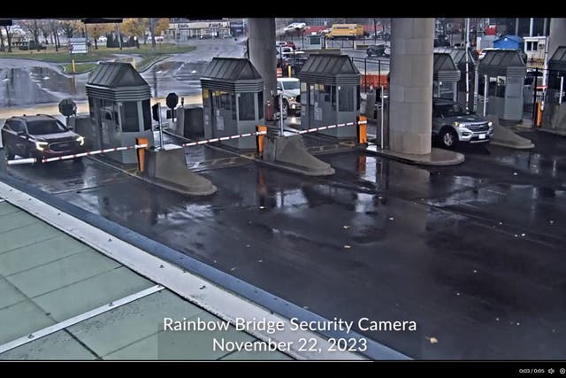 <p>Screengrab from the security camera footage provided by CBP (US Customs and Border Protection) shows a car flying in the background of the US-Canada checkpoint of the Rainbow Bridge border crossing </p>