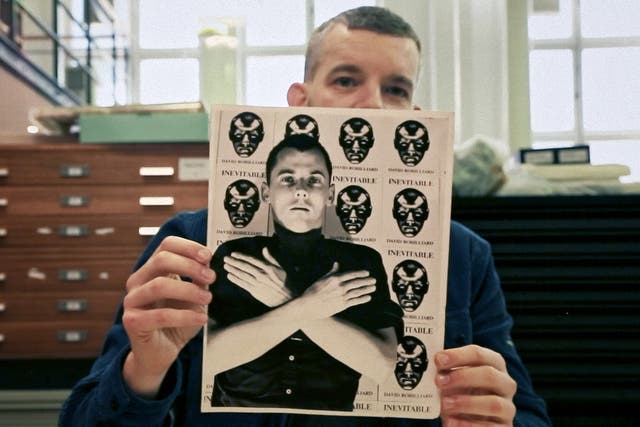 <p>Russell Tovey holds photo of David Robilliard, who poses with prints of his poetry collection ‘Invincible'</p>
